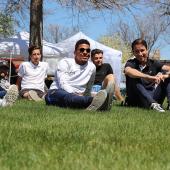 Students sitting on Courthouse lawn in downtown Sterling, Colorado during a music event